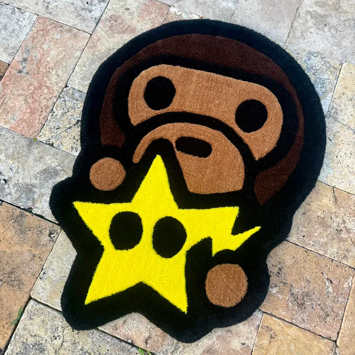 A hand-tufted rug shaped like an ape face holding a yellow star